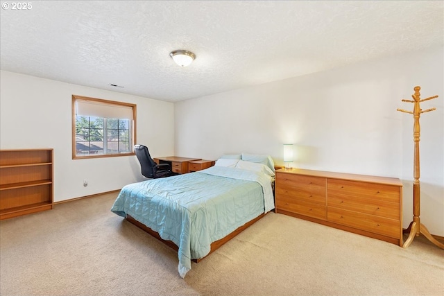 bedroom with light colored carpet, a textured ceiling, and baseboards