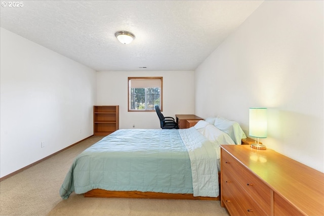 bedroom featuring light carpet, a textured ceiling, and baseboards