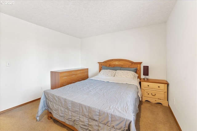 carpeted bedroom featuring a textured ceiling and baseboards