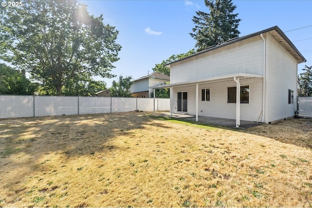 back of property featuring a fenced backyard and a patio