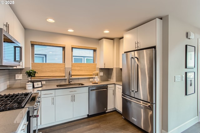 7952 SE 6th Ave, Portland, OR 97202 - kitchen with appliances with stainless steel finishes, a sink, white cabinetry, and recessed lighting