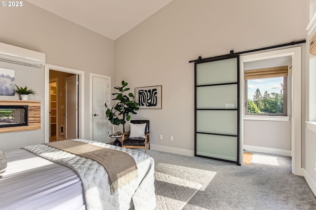 7952 SE 6th Ave, Portland, OR 97202 - bedroom featuring a wall unit AC, carpet, vaulted ceiling, baseboards, and a barn door