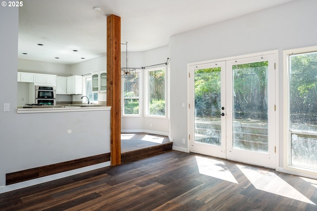 doorway featuring a sink, baseboards, french doors, and dark wood-style floors