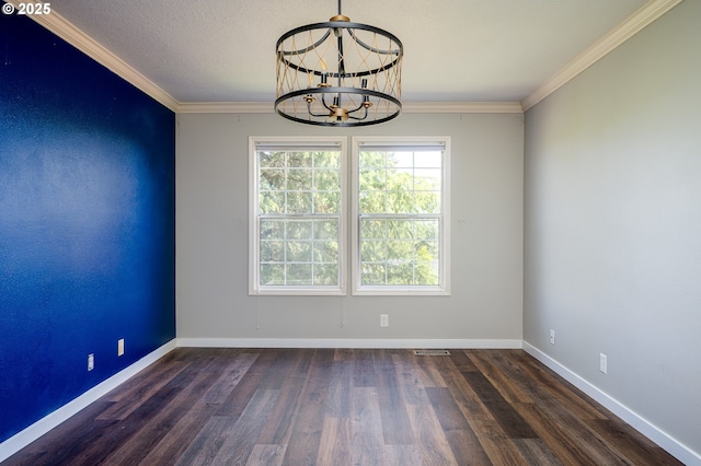 spare room with visible vents, crown molding, wood finished floors, baseboards, and an inviting chandelier
