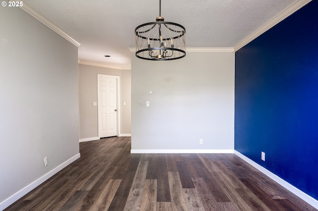 unfurnished dining area featuring crown molding, a notable chandelier, a textured ceiling, baseboards, and wood finished floors