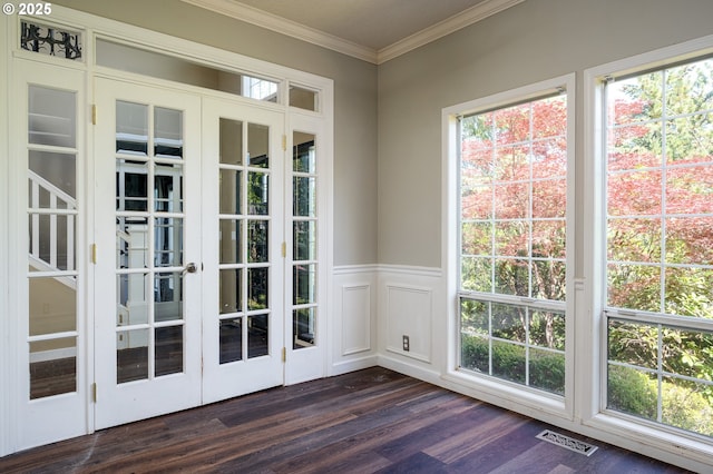 entryway with a wealth of natural light, ornamental molding, dark wood finished floors, and visible vents