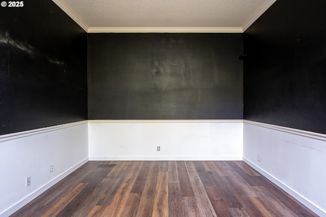 spare room featuring crown molding, baseboards, a textured ceiling, and wood finished floors