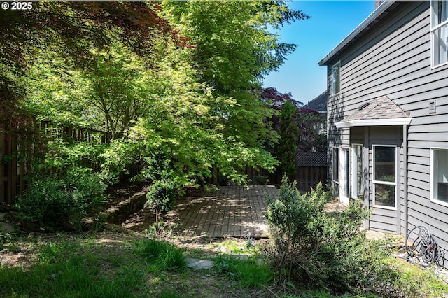 view of yard featuring fence and a wooden deck