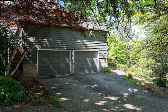garage with aphalt driveway