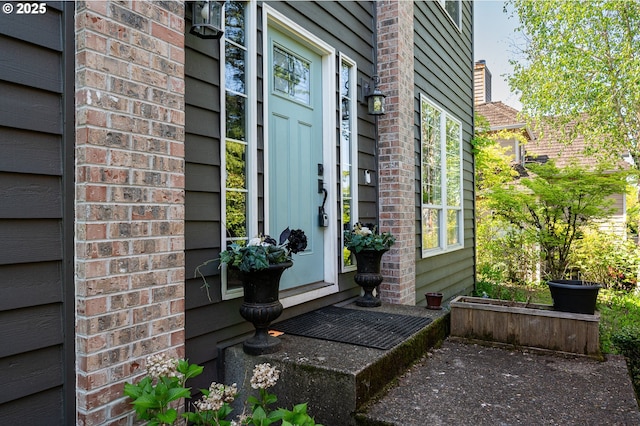 property entrance with brick siding