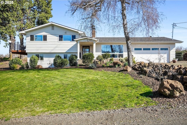 tri-level home featuring a front yard, a chimney, and an attached garage