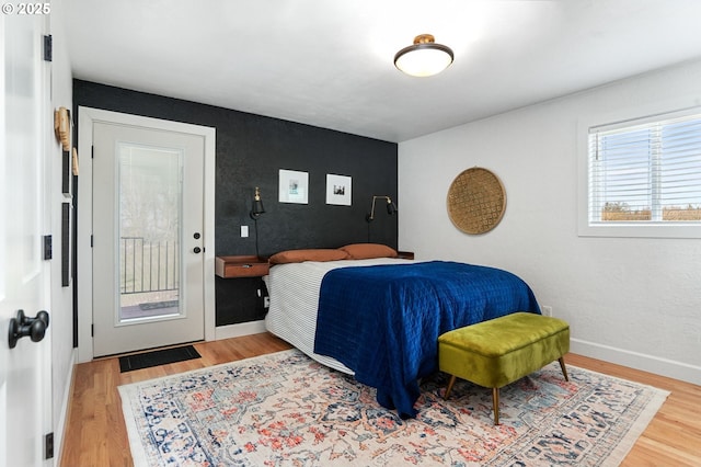 bedroom with baseboards and wood finished floors