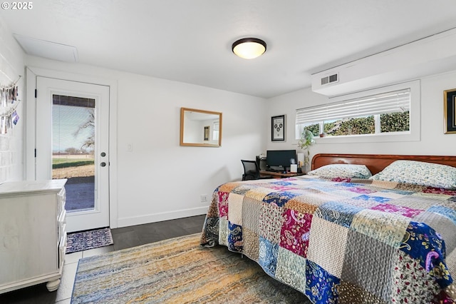 bedroom with visible vents, baseboards, and wood finished floors