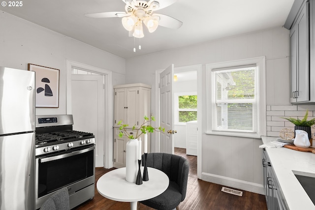 705 Jackson St, Oregon City, OR 97045 - kitchen featuring appliances with stainless steel finishes, light countertops, dark wood-style flooring, a ceiling fan, and baseboards