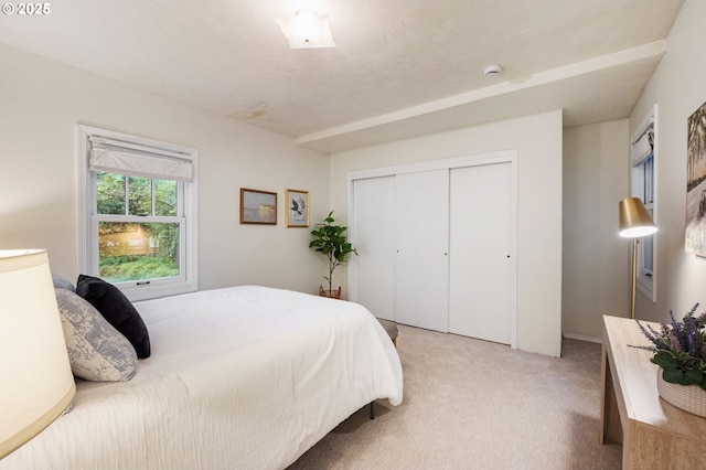 bedroom featuring light carpet and a closet