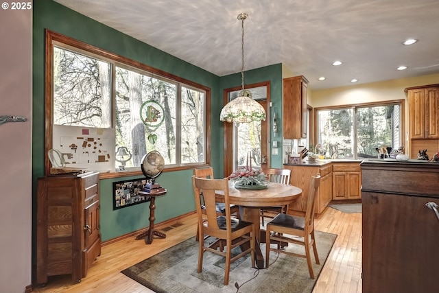 dining space with light wood-type flooring