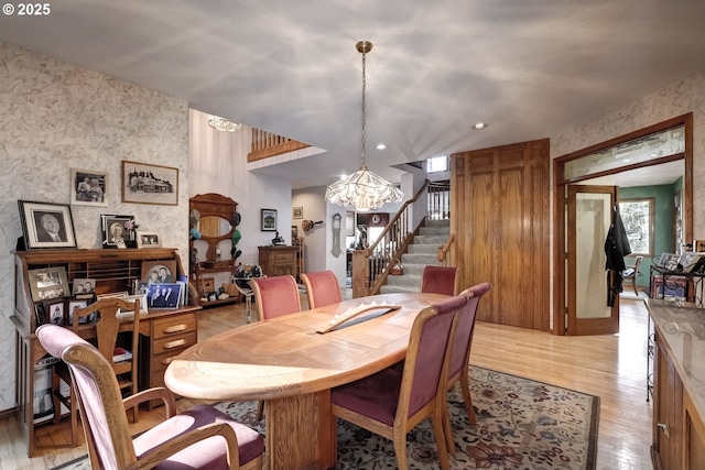 dining area with an inviting chandelier and light hardwood / wood-style floors