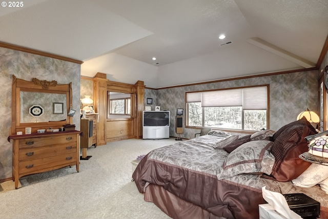 bedroom with light colored carpet, lofted ceiling, and ornamental molding