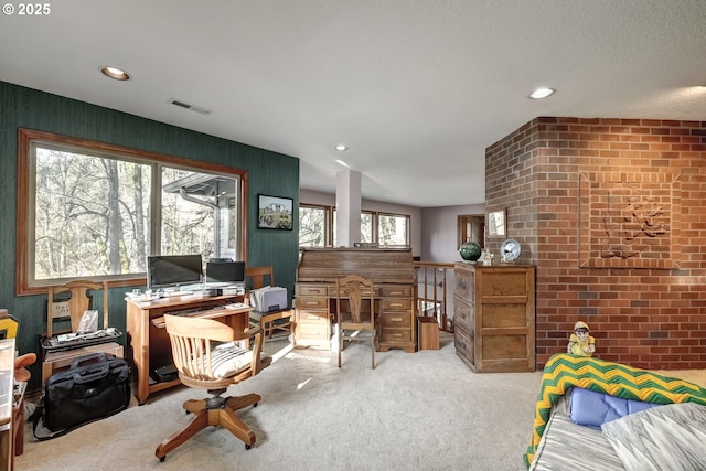 office space with light carpet and brick wall