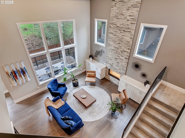 living room with dark wood-type flooring, visible vents, and baseboards