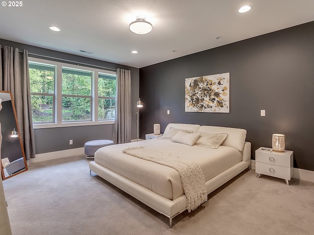 bedroom featuring recessed lighting, visible vents, light colored carpet, and baseboards