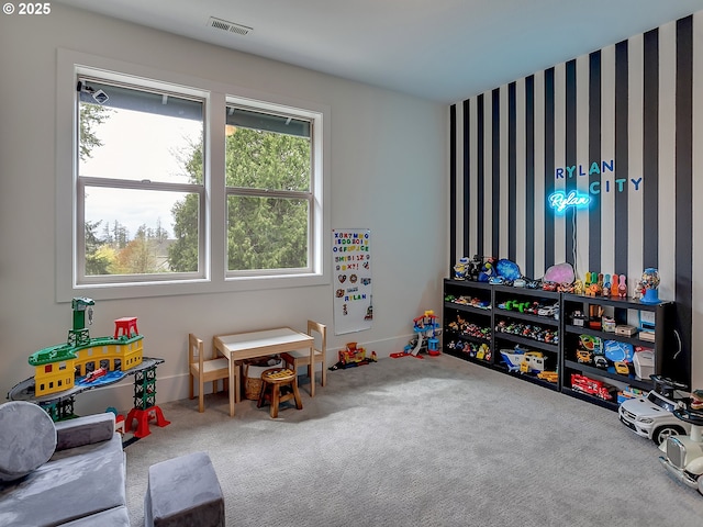 recreation room featuring visible vents, baseboards, and carpet