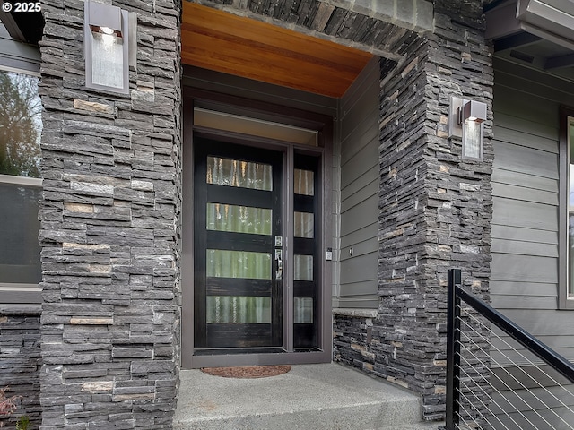 entrance to property featuring stone siding
