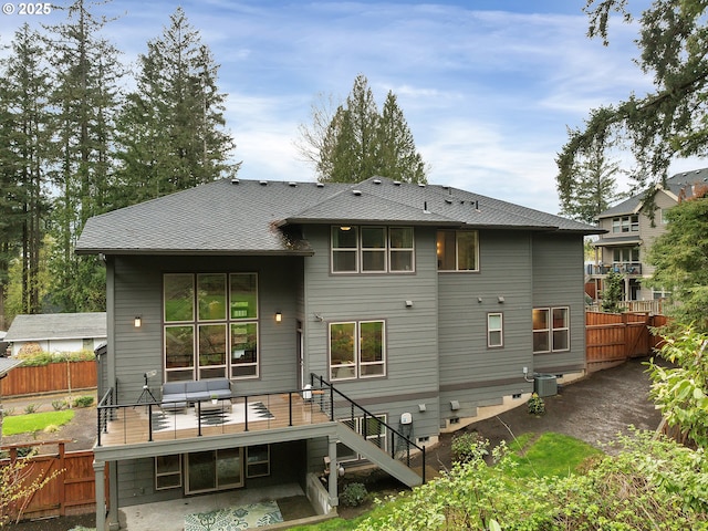 rear view of house featuring central AC unit, fence, a deck, and stairs