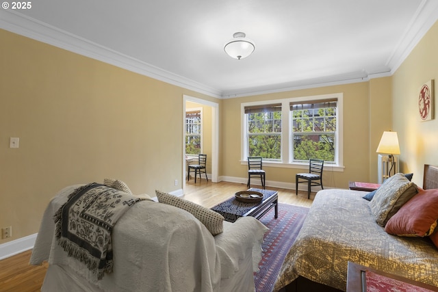 living room with wood finished floors, baseboards, and ornamental molding