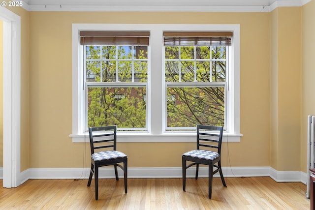 sitting room with a wealth of natural light, baseboards, and wood finished floors