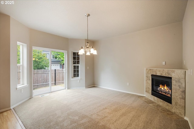 1988 NE 54th Way, Hillsboro, OR 97124 - unfurnished living room featuring a chandelier, a tile fireplace, baseboards, and light carpet
