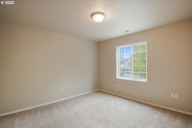 1988 NE 54th Way, Hillsboro, OR 97124 - unfurnished room featuring light colored carpet, a textured ceiling, and baseboards