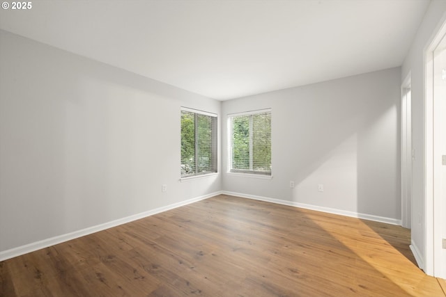 5130 SW Multnomah Blvd Unit H, Portland, OR 97219 - empty room with baseboards and wood finished floors