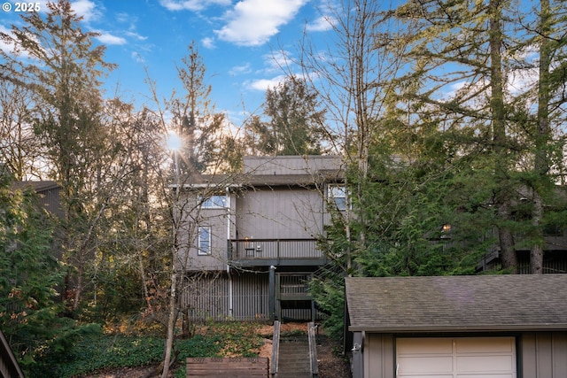 back of house with roof with shingles