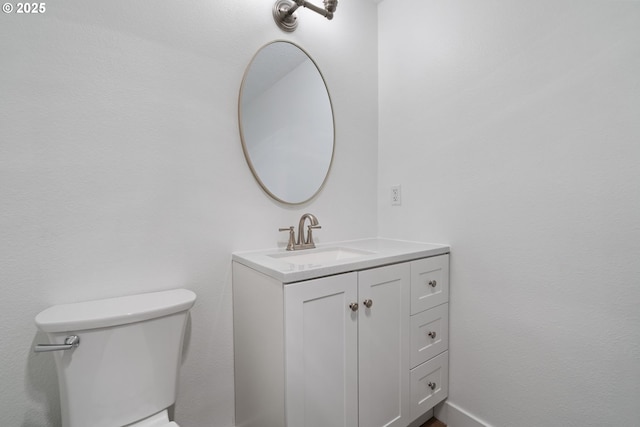 bathroom with toilet and vanity