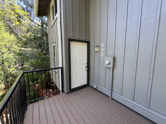 doorway to property featuring a balcony and board and batten siding
