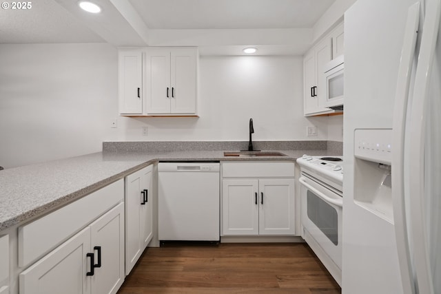 kitchen featuring a sink, white appliances, white cabinetry, and recessed lighting