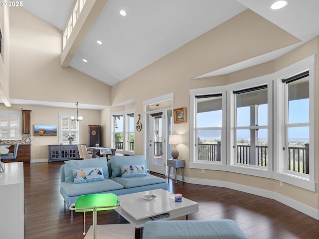 living room with dark wood-style floors, beam ceiling, recessed lighting, an inviting chandelier, and baseboards