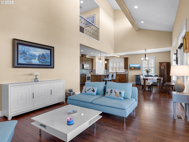 living area featuring dark wood-type flooring, recessed lighting, visible vents, and an inviting chandelier