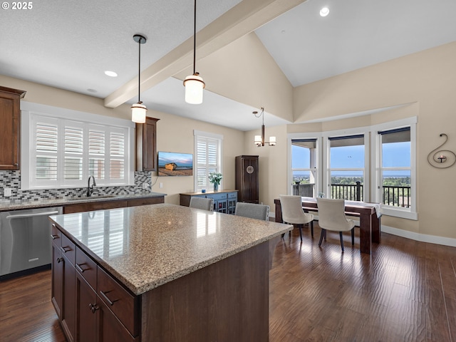 kitchen with a wealth of natural light, decorative backsplash, dishwasher, a center island, and a sink