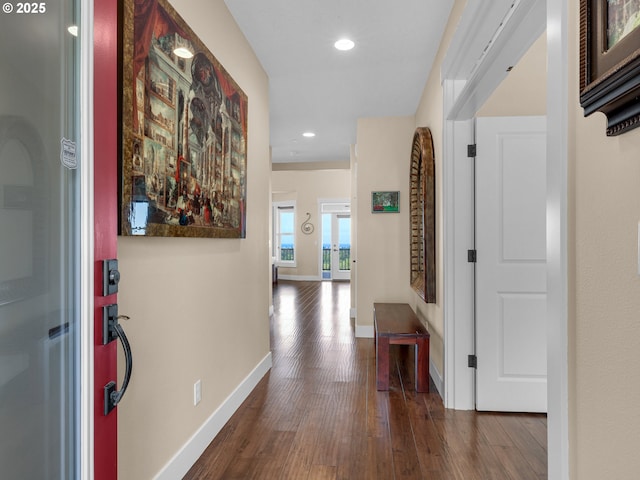 corridor featuring recessed lighting, baseboards, and wood finished floors