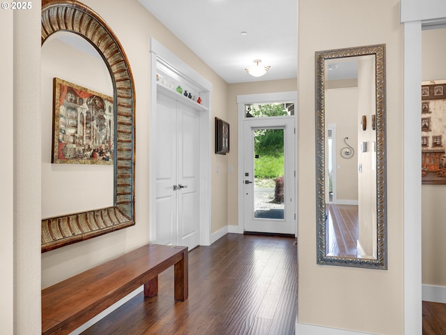 entryway with baseboards and dark wood finished floors