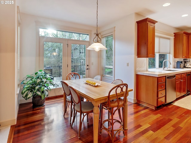 dining space featuring hardwood / wood-style flooring, a healthy amount of sunlight, and sink