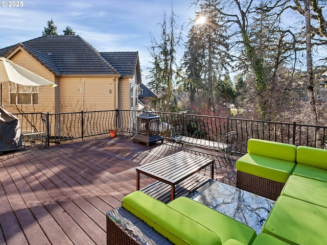 wooden terrace featuring an outdoor hangout area and a grill