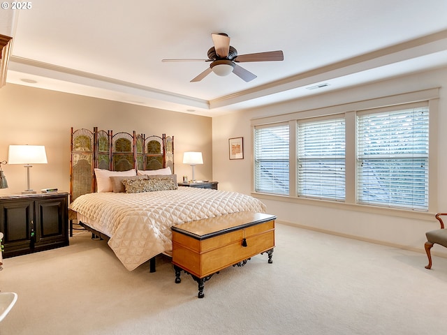 bedroom with light carpet, a raised ceiling, ceiling fan, and crown molding