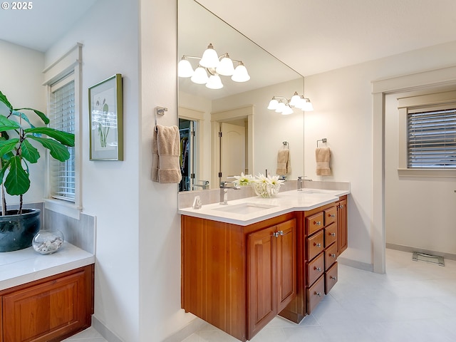 bathroom with vanity and an inviting chandelier