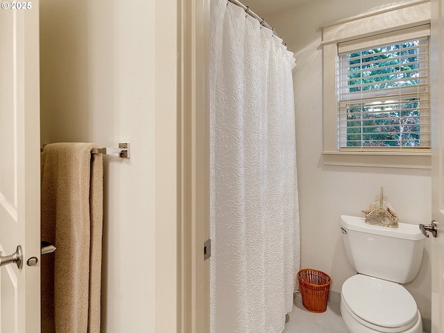 bathroom with tile patterned flooring and toilet