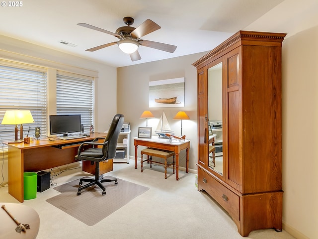 carpeted office featuring ceiling fan