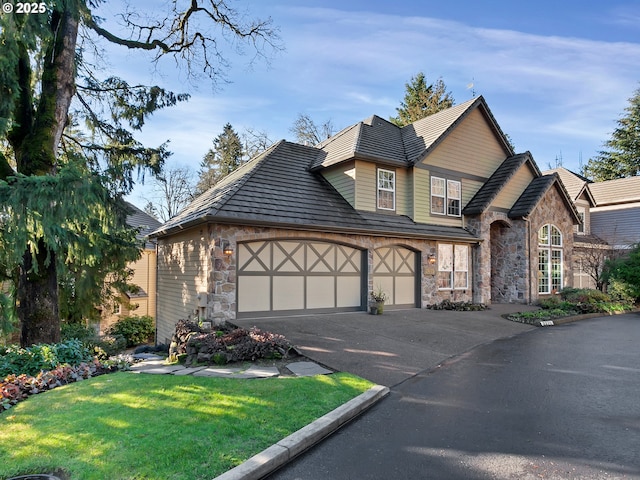 view of front of home with a front lawn and a garage