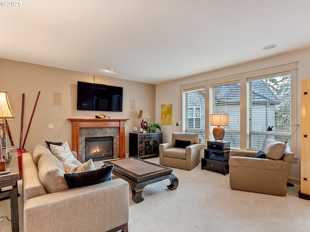 carpeted living room featuring a tiled fireplace